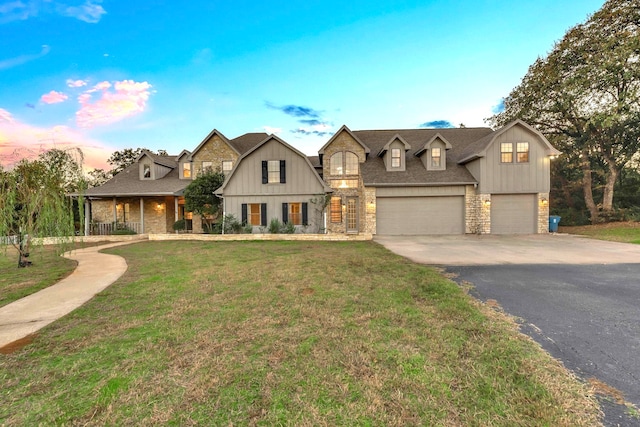 view of front of home with a lawn and a garage