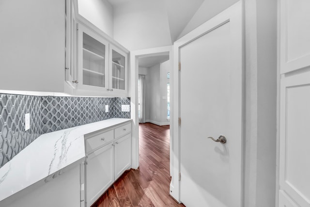 7170 Fm 1830, Argyle, TX 76226 - kitchen with glass insert cabinets, white cabinetry, dark wood-style floors, and light stone counters