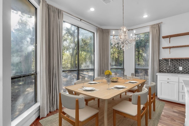 dining room featuring an inviting chandelier and light hardwood / wood-style flooring