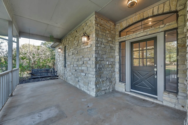 view of exterior entry with a porch