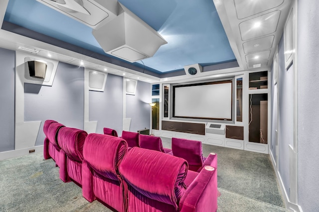 home theater featuring a raised ceiling and carpet floors