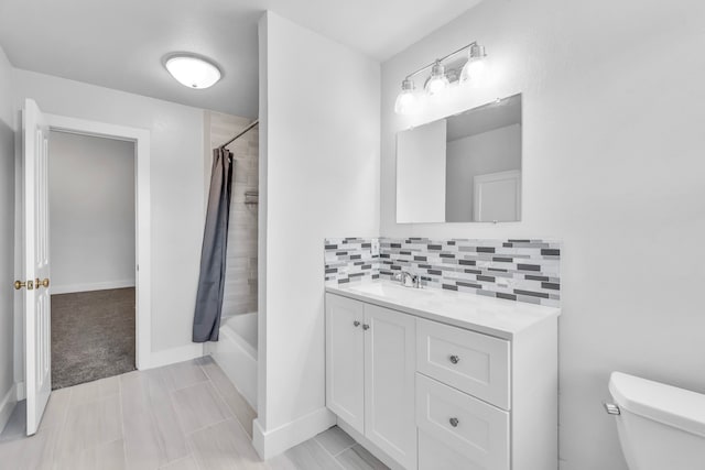 full bathroom with decorative backsplash, shower / bath combo, vanity, tile patterned flooring, and toilet