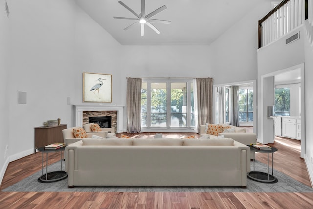 7170 Fm 1830, Argyle, TX 76226 - living area featuring high vaulted ceiling, a ceiling fan, plenty of natural light, a fireplace, and wood finished floors
