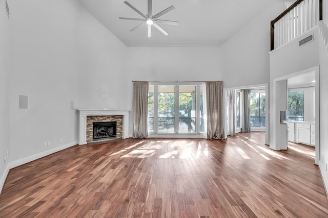 7170 Fm 1830, Argyle, TX 76226 - unfurnished living room with high vaulted ceiling, a ceiling fan, plenty of natural light, wood finished floors, and a fireplace