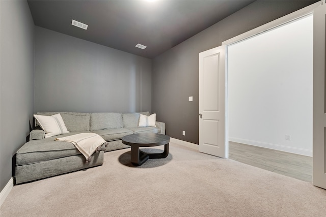 living area with light colored carpet and lofted ceiling