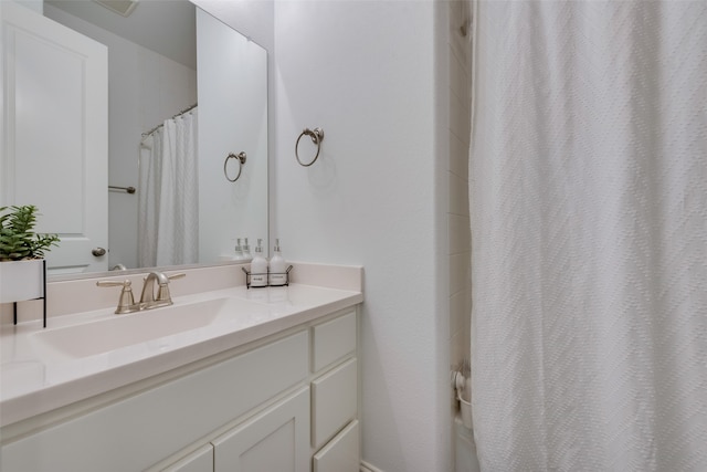 bathroom featuring vanity and curtained shower