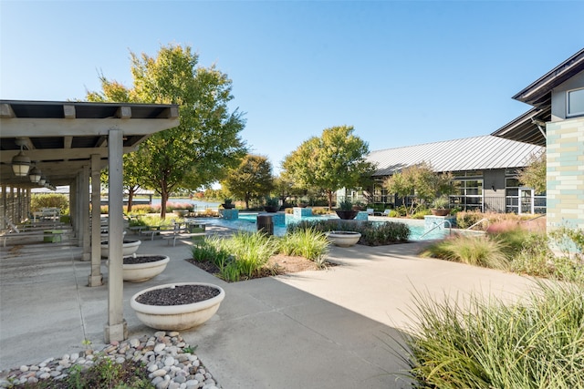 view of home's community featuring a patio area and a pool