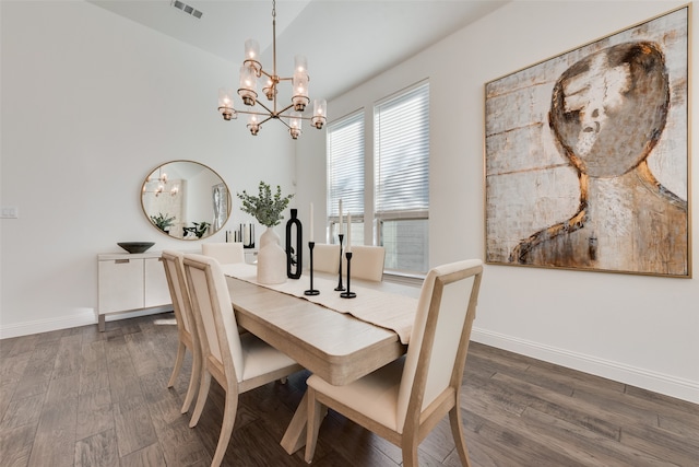 dining space featuring vaulted ceiling, dark hardwood / wood-style flooring, and a chandelier