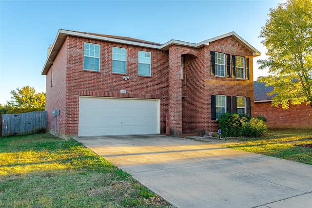 view of front of home featuring a garage and a front lawn