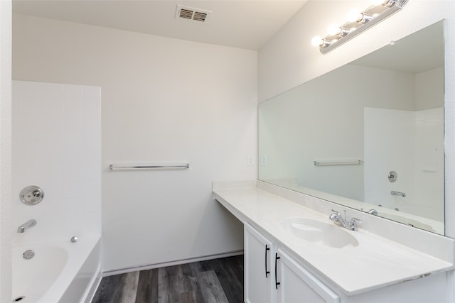 bathroom with shower / bath combination, vanity, and hardwood / wood-style flooring