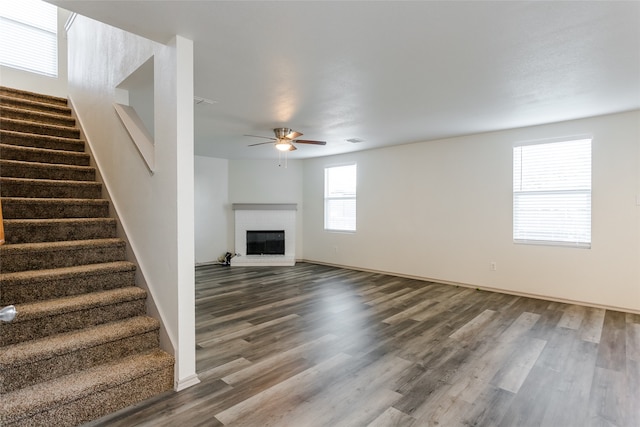 unfurnished living room with hardwood / wood-style flooring and ceiling fan