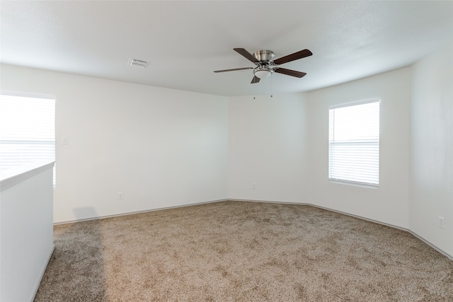 spare room with ceiling fan and carpet floors