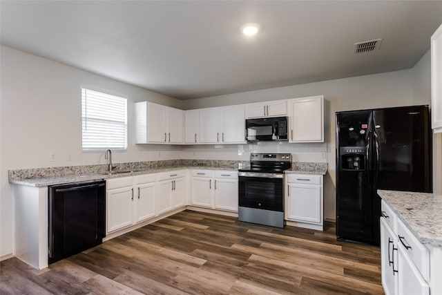 kitchen featuring dark hardwood / wood-style flooring, white cabinets, black appliances, and sink