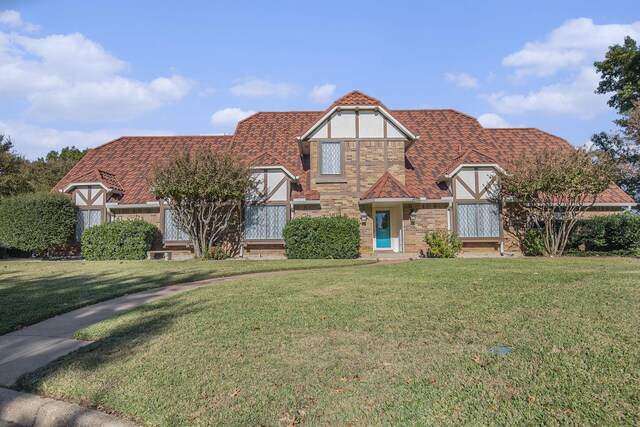 tudor home with a front yard