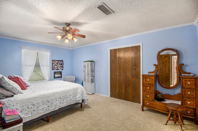 carpeted bedroom with ceiling fan, crown molding, and a textured ceiling