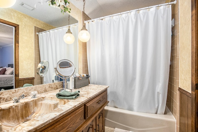 bathroom featuring vanity, shower / tub combo, and a textured ceiling