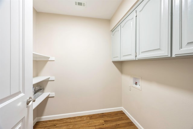 laundry room with hookup for a washing machine, dark hardwood / wood-style floors, and cabinets