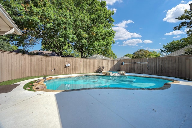 view of swimming pool featuring an in ground hot tub and a patio