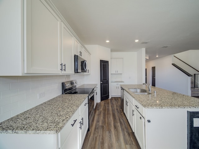 kitchen featuring white cabinetry, sink, dark hardwood / wood-style floors, a kitchen island with sink, and appliances with stainless steel finishes