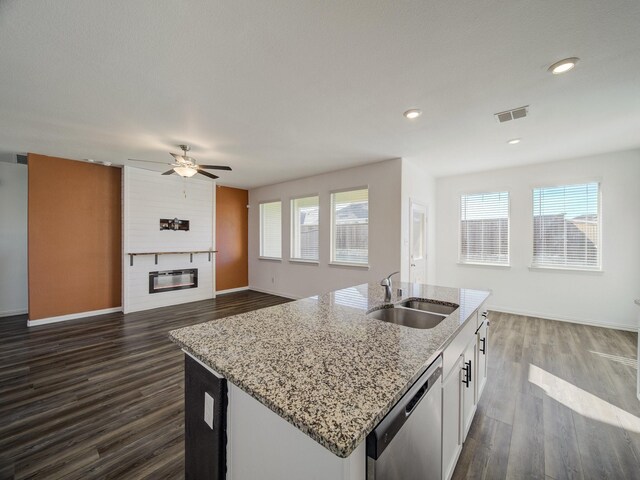 kitchen with white cabinets, dishwasher, plenty of natural light, and sink