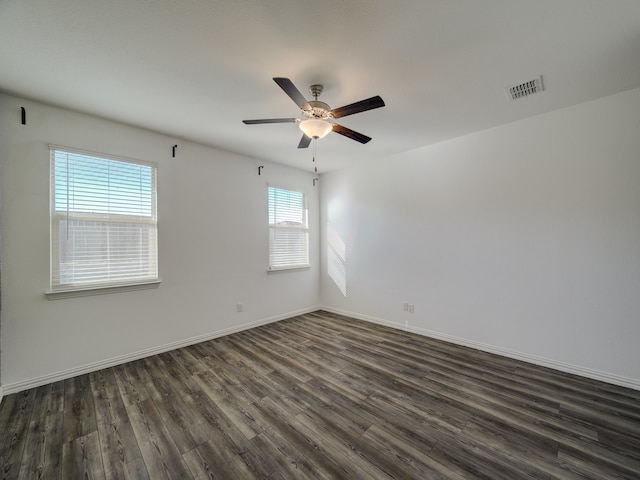 unfurnished room with dark hardwood / wood-style flooring, ceiling fan, and a healthy amount of sunlight