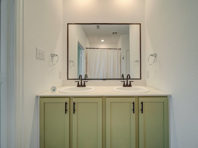 bathroom featuring vanity and curtained shower