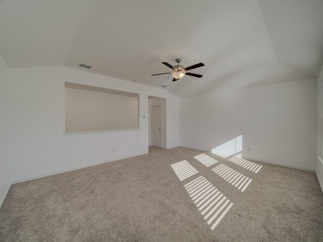 interior space with ceiling fan, light carpet, and vaulted ceiling