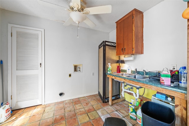 kitchen with a textured ceiling, ceiling fan, and sink