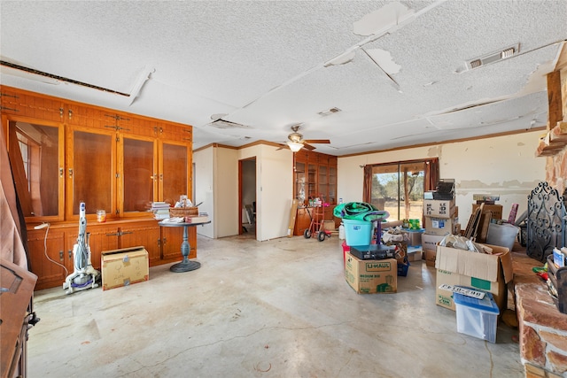 misc room with a textured ceiling and ceiling fan