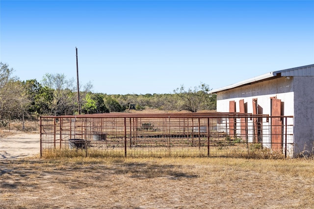 view of yard with an outbuilding and a rural view