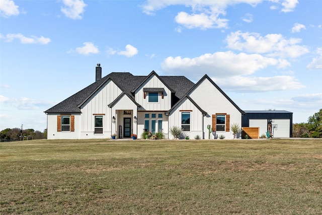 modern inspired farmhouse featuring an outbuilding and a front yard