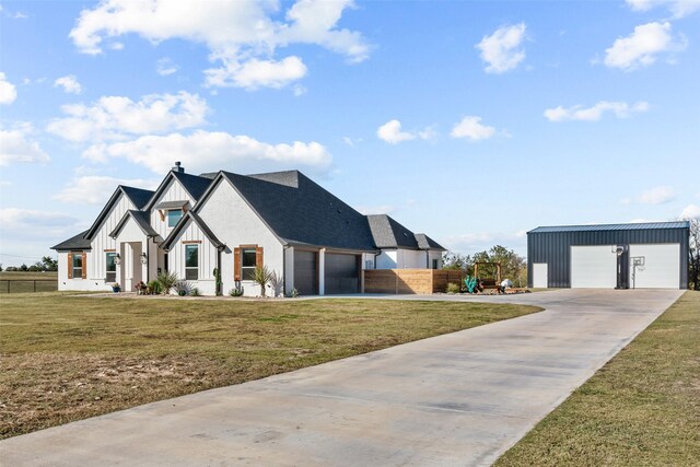 view of front of property with a garage and a front lawn