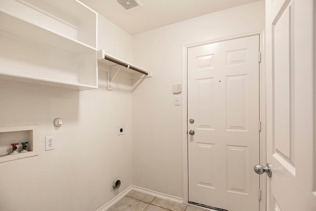 washroom featuring electric dryer hookup, hookup for a gas dryer, hookup for a washing machine, and light tile patterned floors