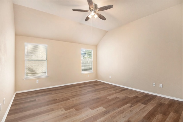 empty room with ceiling fan, wood-type flooring, and lofted ceiling