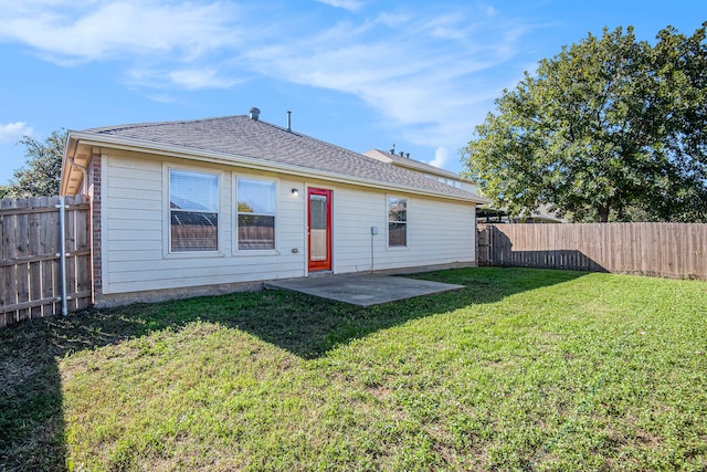 back of house with a patio area and a yard