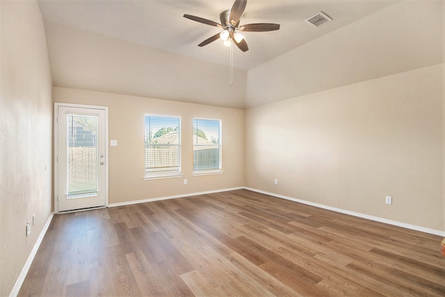 unfurnished room with ceiling fan, vaulted ceiling, and light hardwood / wood-style flooring