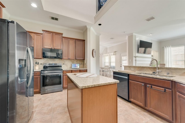 kitchen with light stone countertops, a center island, sink, stainless steel appliances, and light tile patterned floors