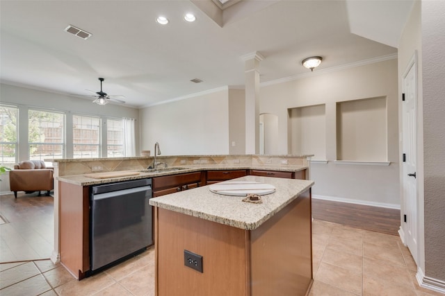 kitchen with dishwasher, light tile patterned floors, a kitchen island, and ceiling fan