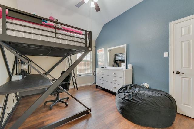 bedroom with ceiling fan, wood-type flooring, and vaulted ceiling