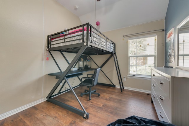 bedroom featuring dark hardwood / wood-style flooring and vaulted ceiling