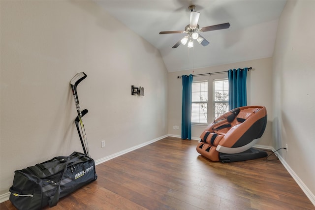 sitting room with ceiling fan, dark wood-type flooring, and lofted ceiling