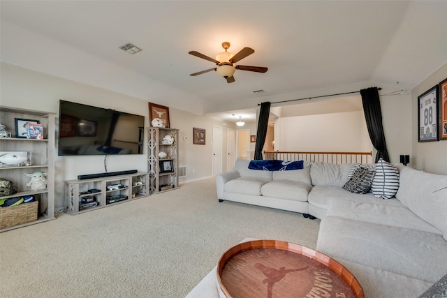 carpeted living room featuring ceiling fan and vaulted ceiling