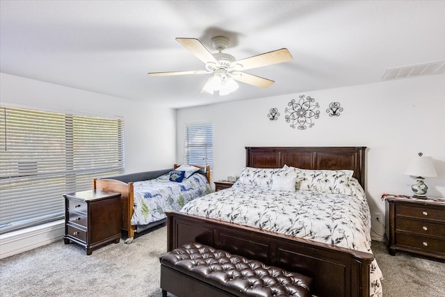 bedroom with ceiling fan and light carpet