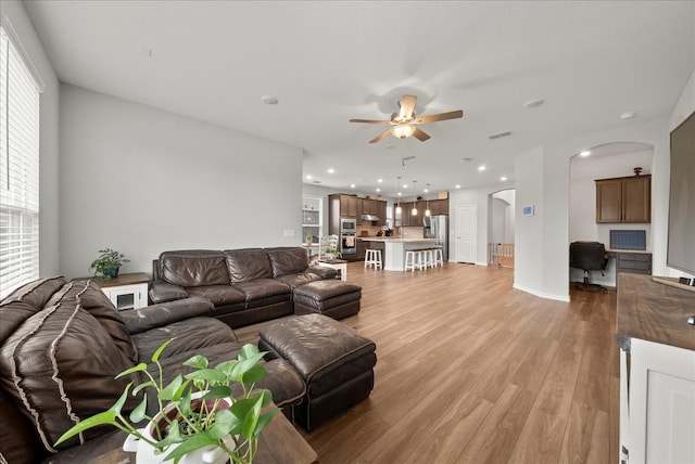 living room with ceiling fan and light hardwood / wood-style floors