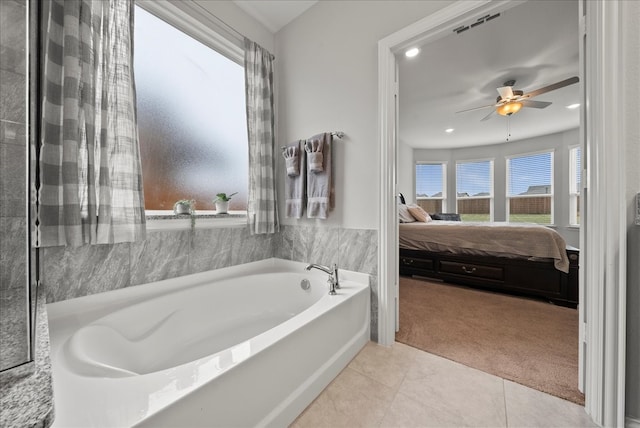 bathroom with tile patterned floors, ceiling fan, and a bath