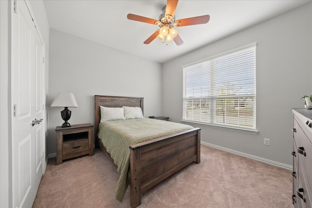 bedroom featuring light carpet and ceiling fan