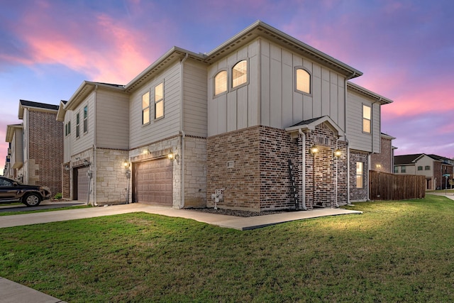 view of front facade featuring a garage and a lawn