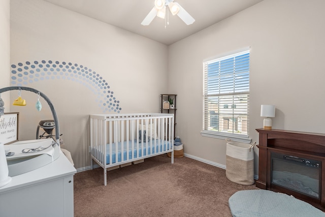 bedroom featuring carpet floors, a nursery area, and ceiling fan