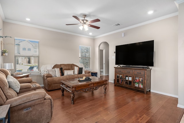 living room with hardwood / wood-style flooring, ceiling fan, and ornamental molding