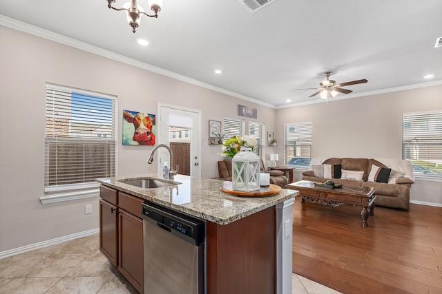 kitchen featuring stainless steel dishwasher, light hardwood / wood-style floors, sink, and a wealth of natural light